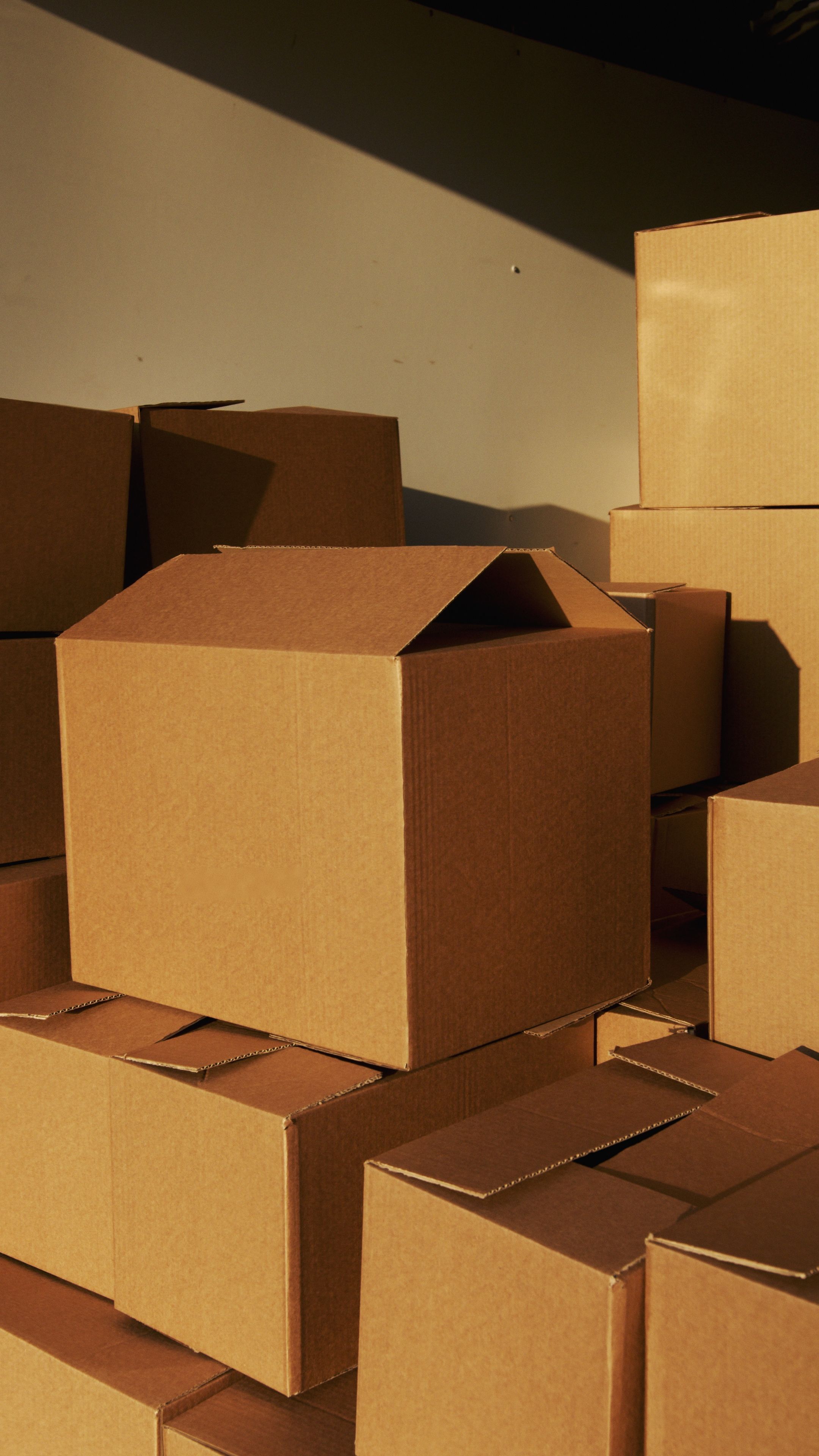Stacked corrugated shipping boxes with visible fluted board edges